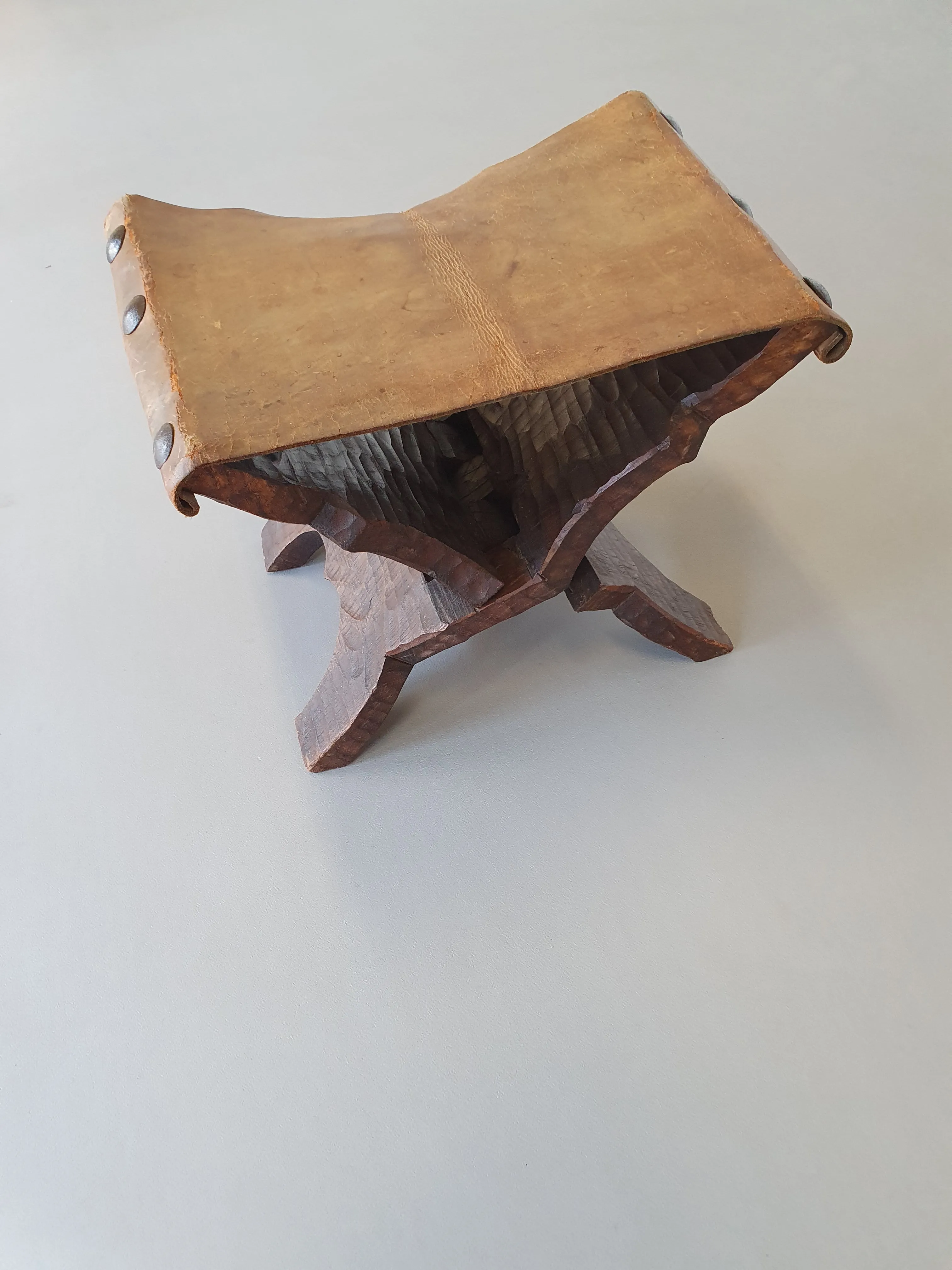 Small brutalist folding stool with leather seat 1950s
