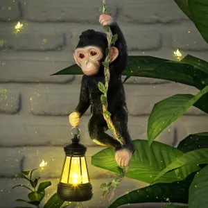 Solar Light Outdoor Statues 7.48'' H Resin Chimpanzee Baby Monkey Climbing On A 19.68" L Vine with LED Lantern Waterproof Hanging Monkey Figurine with Hook for Yard Garden Wall (Black)